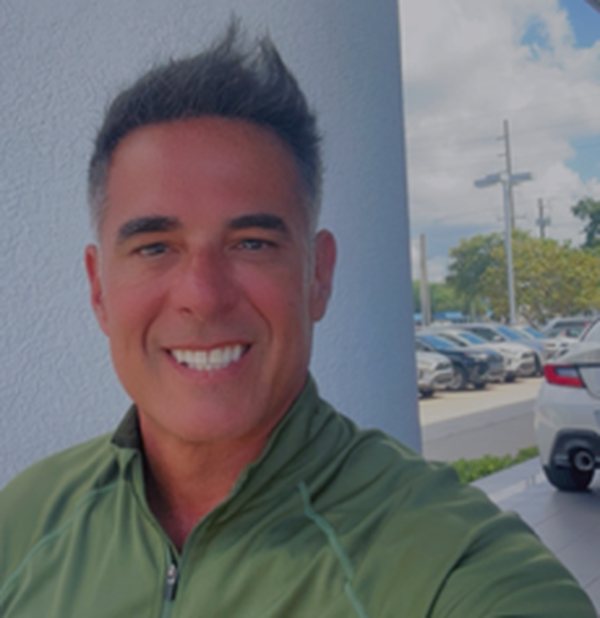 Jeffrey Beauregard outside the dealership on a windy day